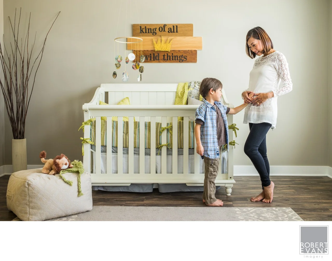 A quiet portrait of an expectant mother sharing a moment with her child, capturing the anticipation and connection of a growing family.