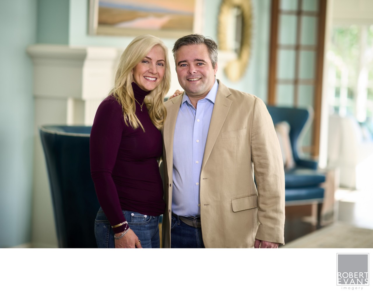 A warm, relaxed portrait of a couple photographed in their home, creating a natural image focused on connection, personality and genuine expression.