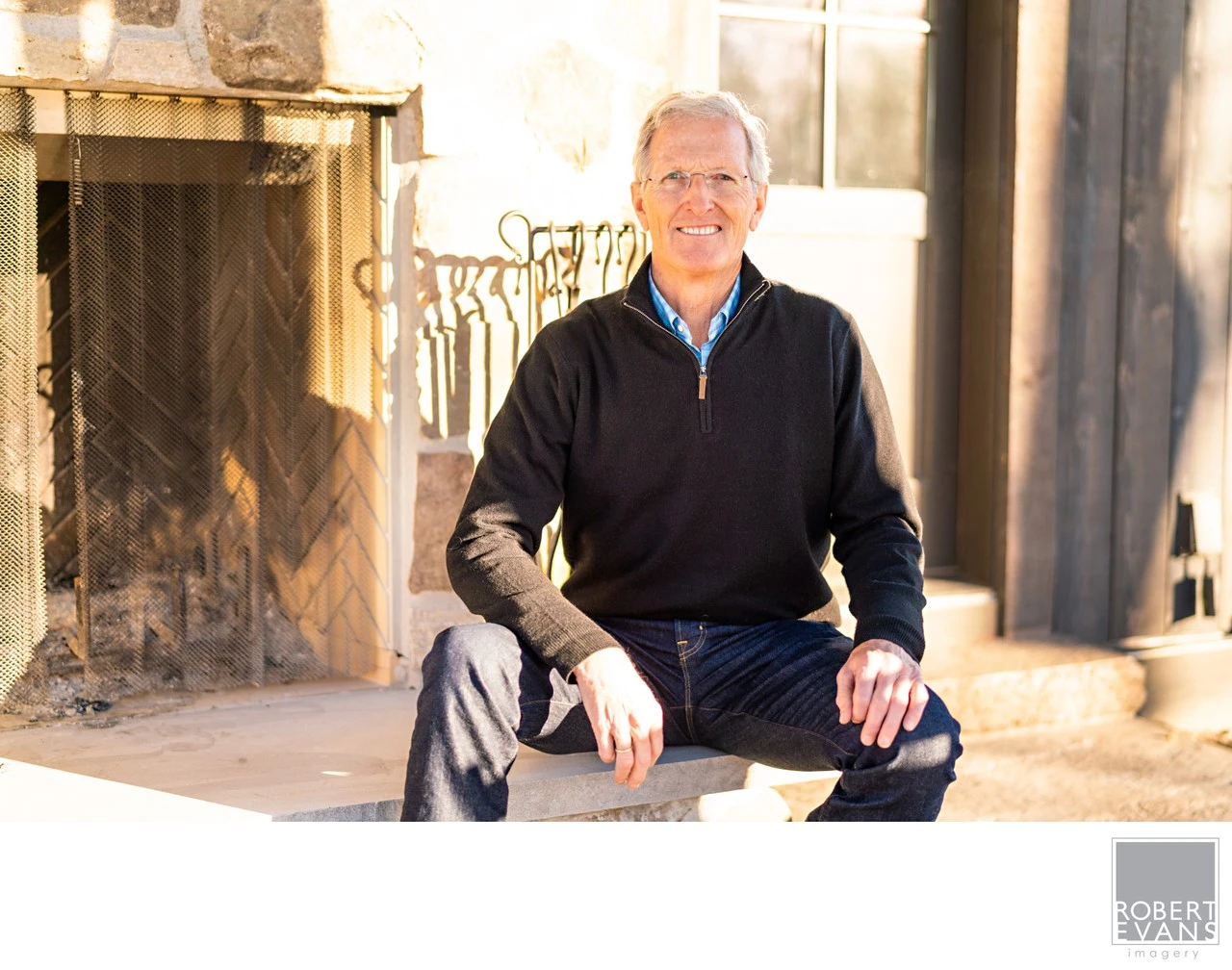 A natural portrait photographed in a comfortable home setting, using the surrounding architecture and available light to create a relaxed, personal image for Greg Page.