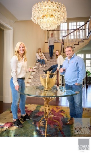 A relaxed family portrait created throughout the family home, using the staircase and surrounding architecture to capture everyone naturally in a setting that is uniquely theirs.
