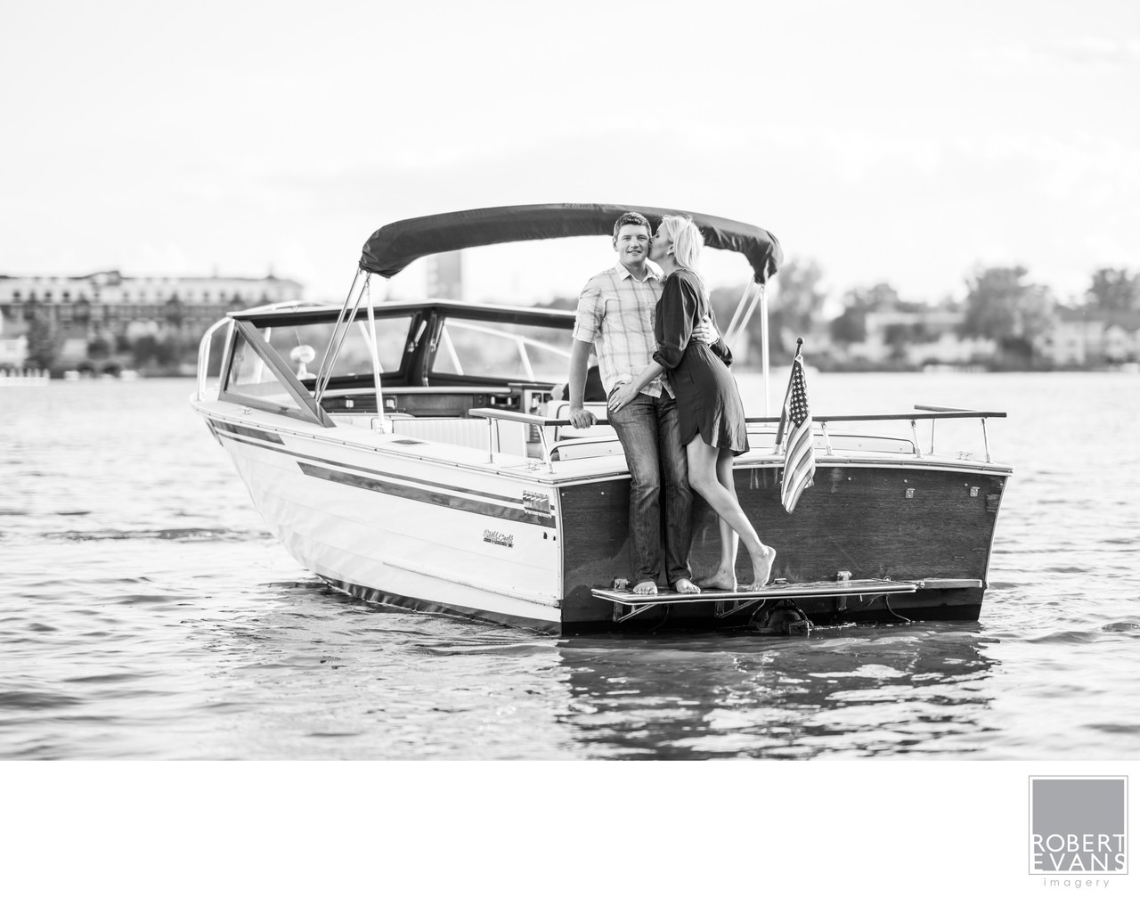 Black-and-white family portrait on a classic boat on Lake Minnetonka
