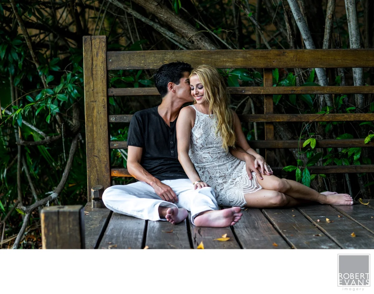 A couple sits close together on wooden steps.
