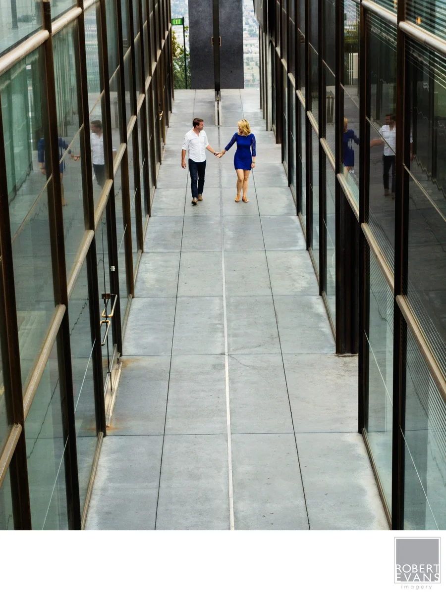 A couple walks together through a covered walkway.