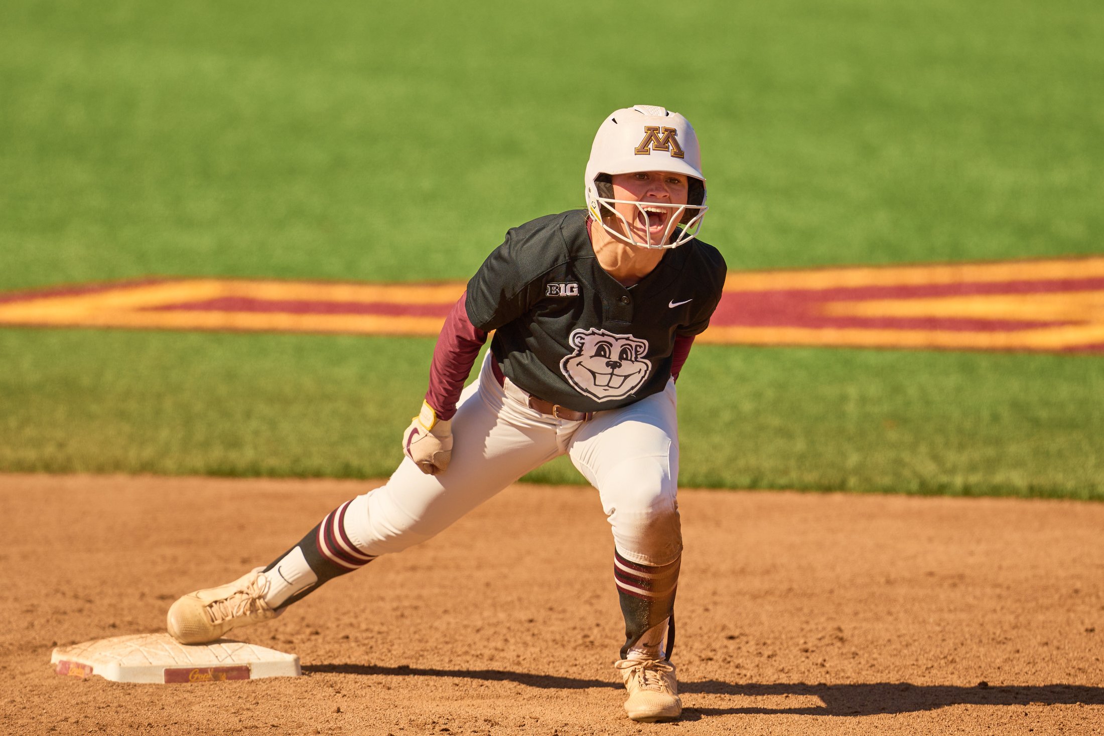A Minnesota softball runner celebrates beside the base during a fall game against Iowa State on October 4, 2026.