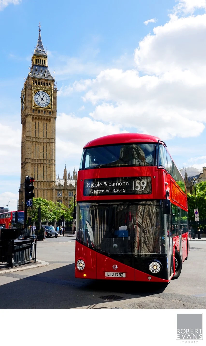 A red double-decker bus passes beside Big Ben under a blue London sky.