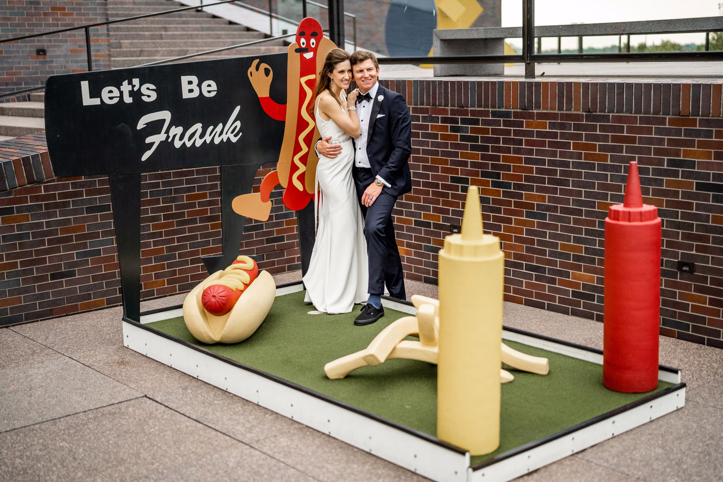 Ali and Drew pose beside a playful Let’s Be Frank hot-dog display at the Walker Art Center
