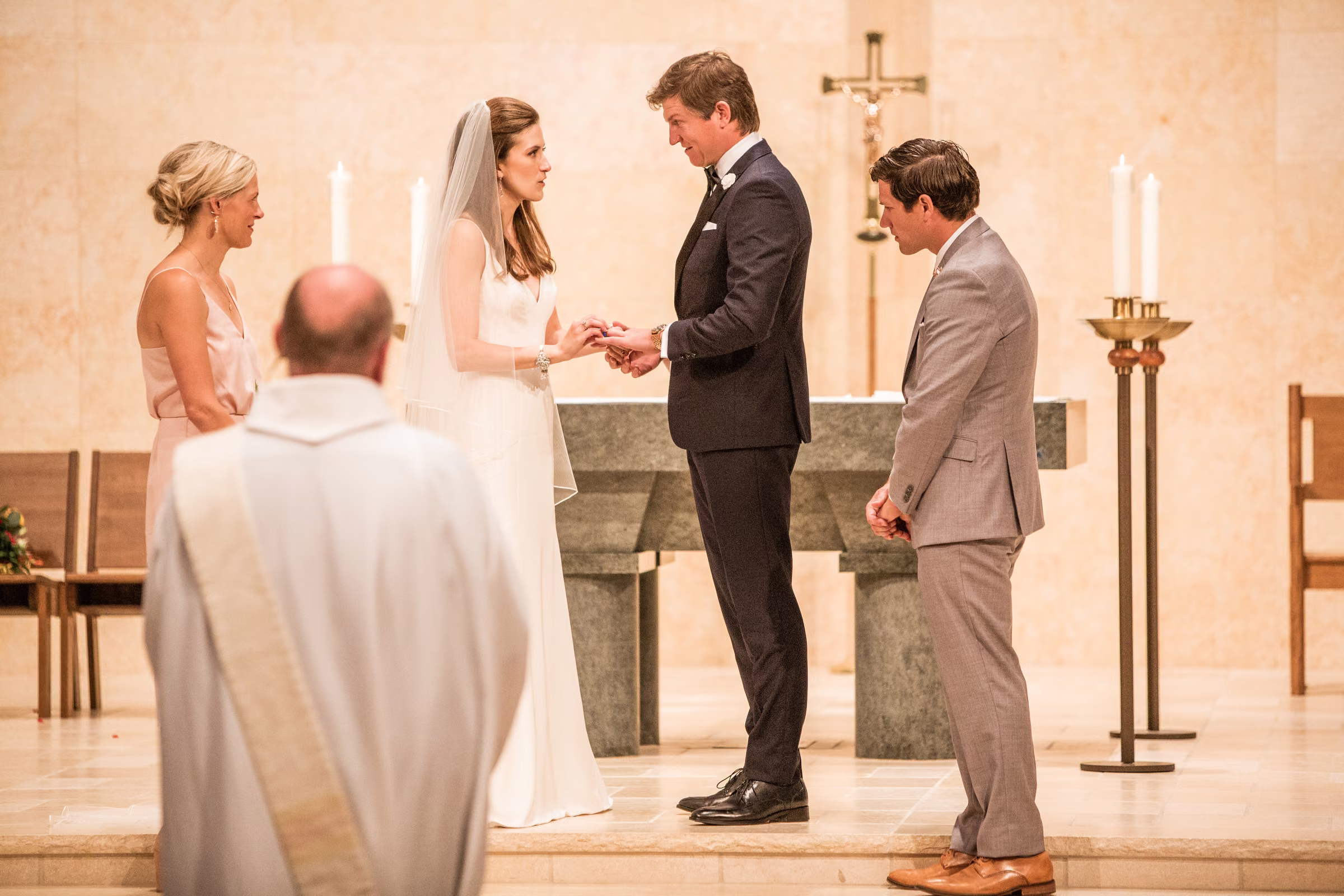 Drew places a wedding ring on Ali’s hand during their church ceremony