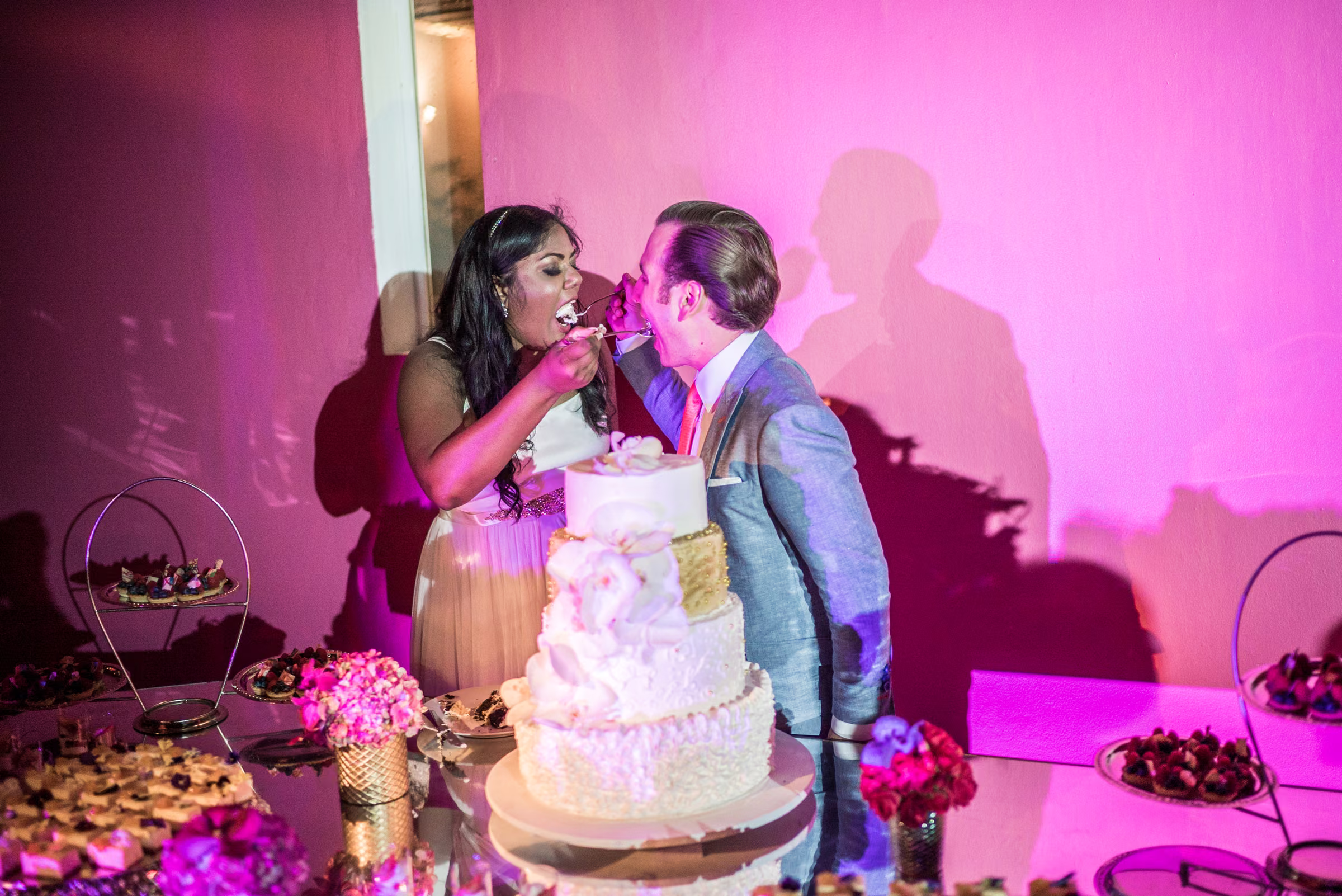 Avanti and Tony feed each other wedding cake