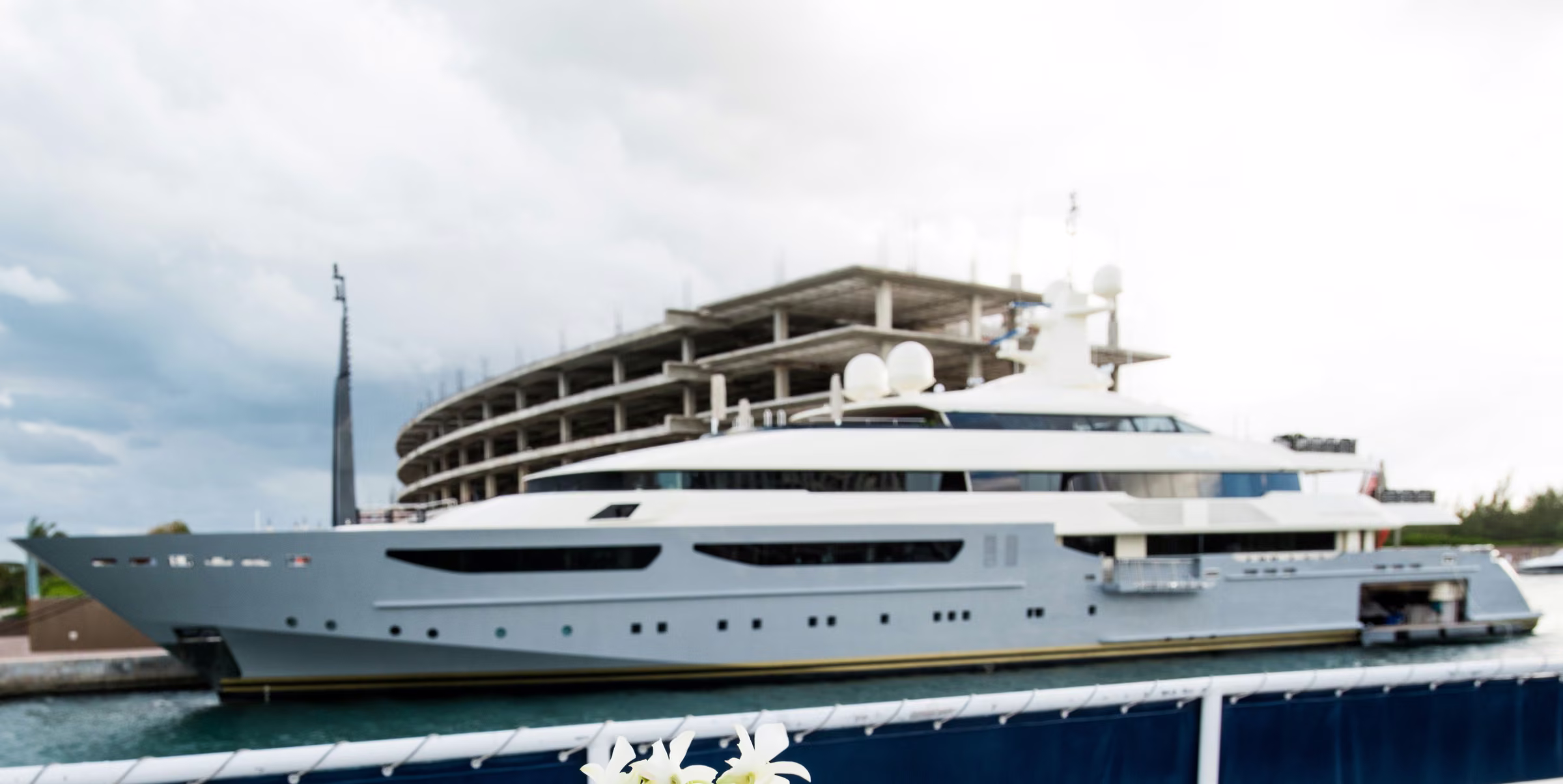 A white yacht moored beside the dock before Avanti and Tony’s welcome dinner