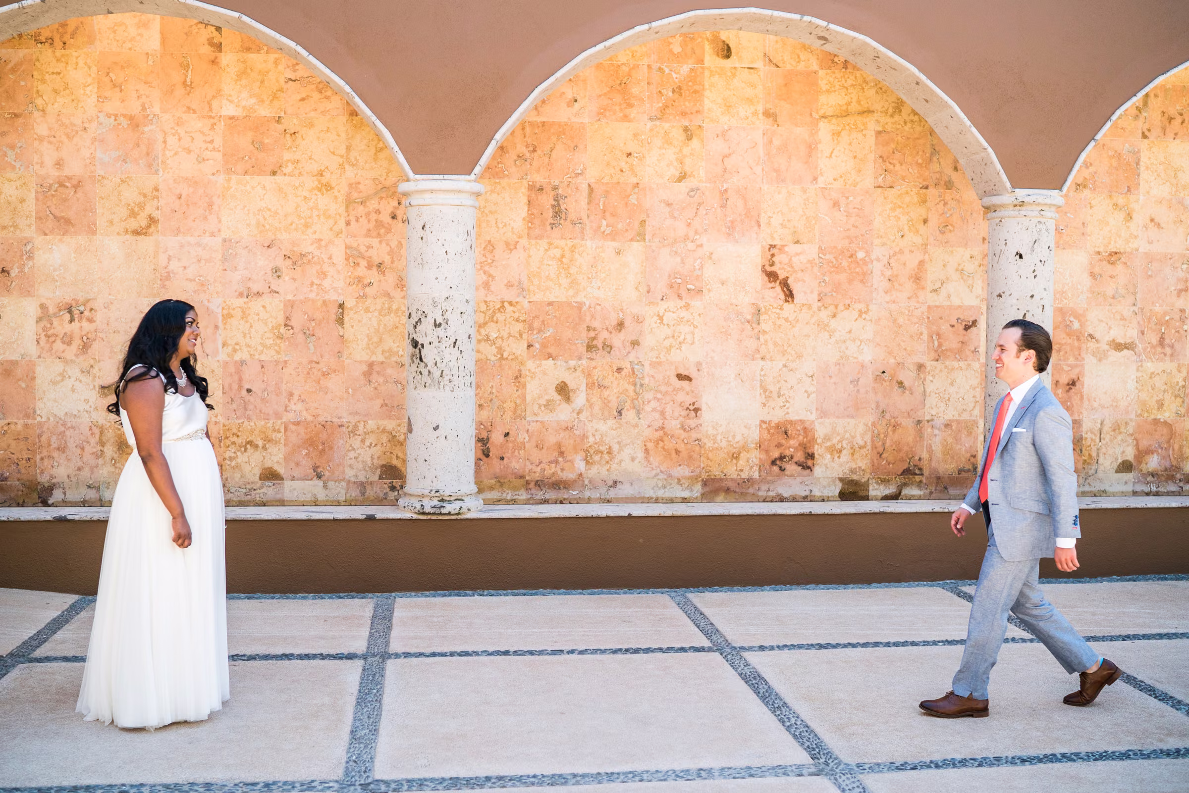 Tony walks toward Avanti beneath stone arches for their first look