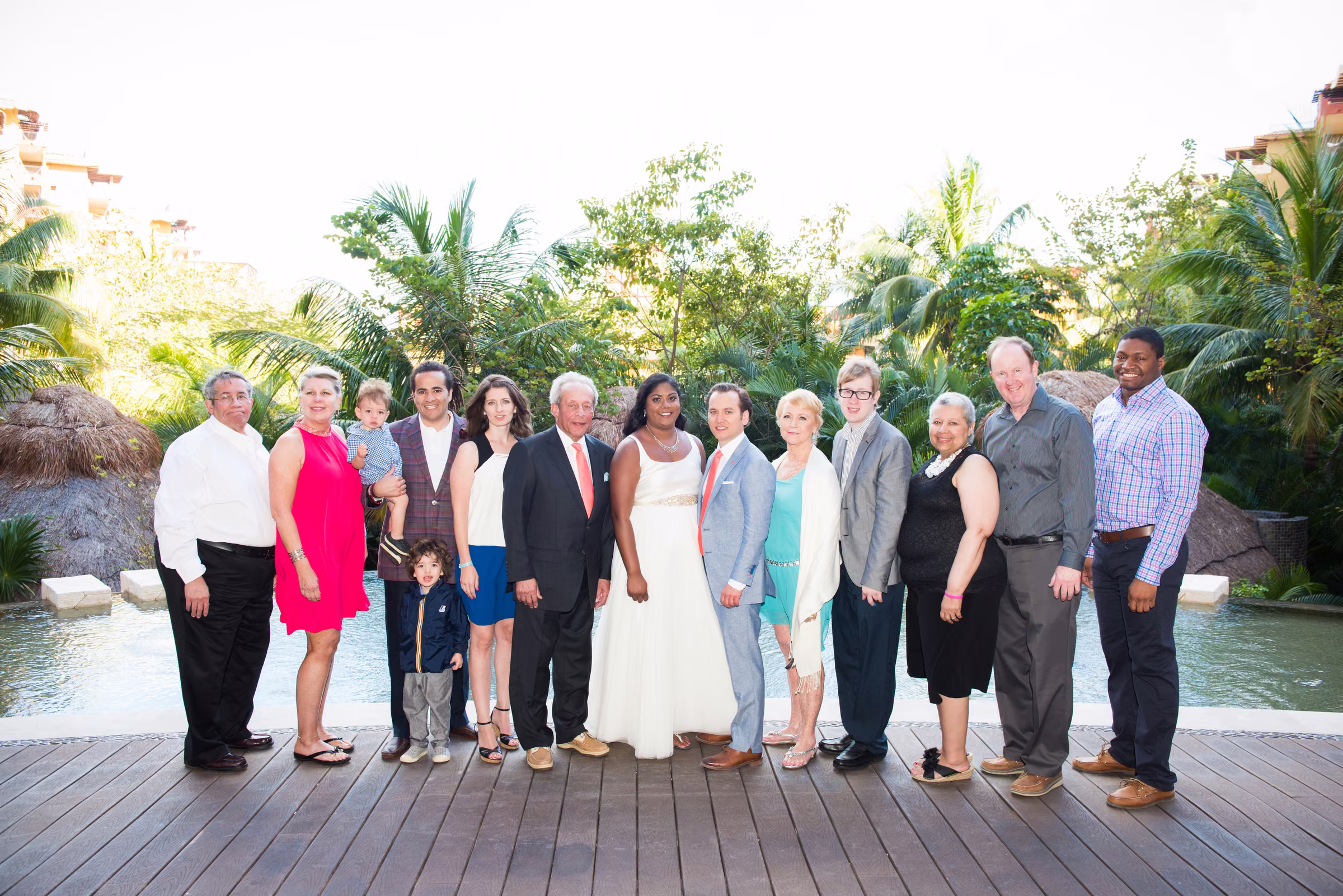 Avanti and Tony pose with the groom’s family on an outdoor wooden deck