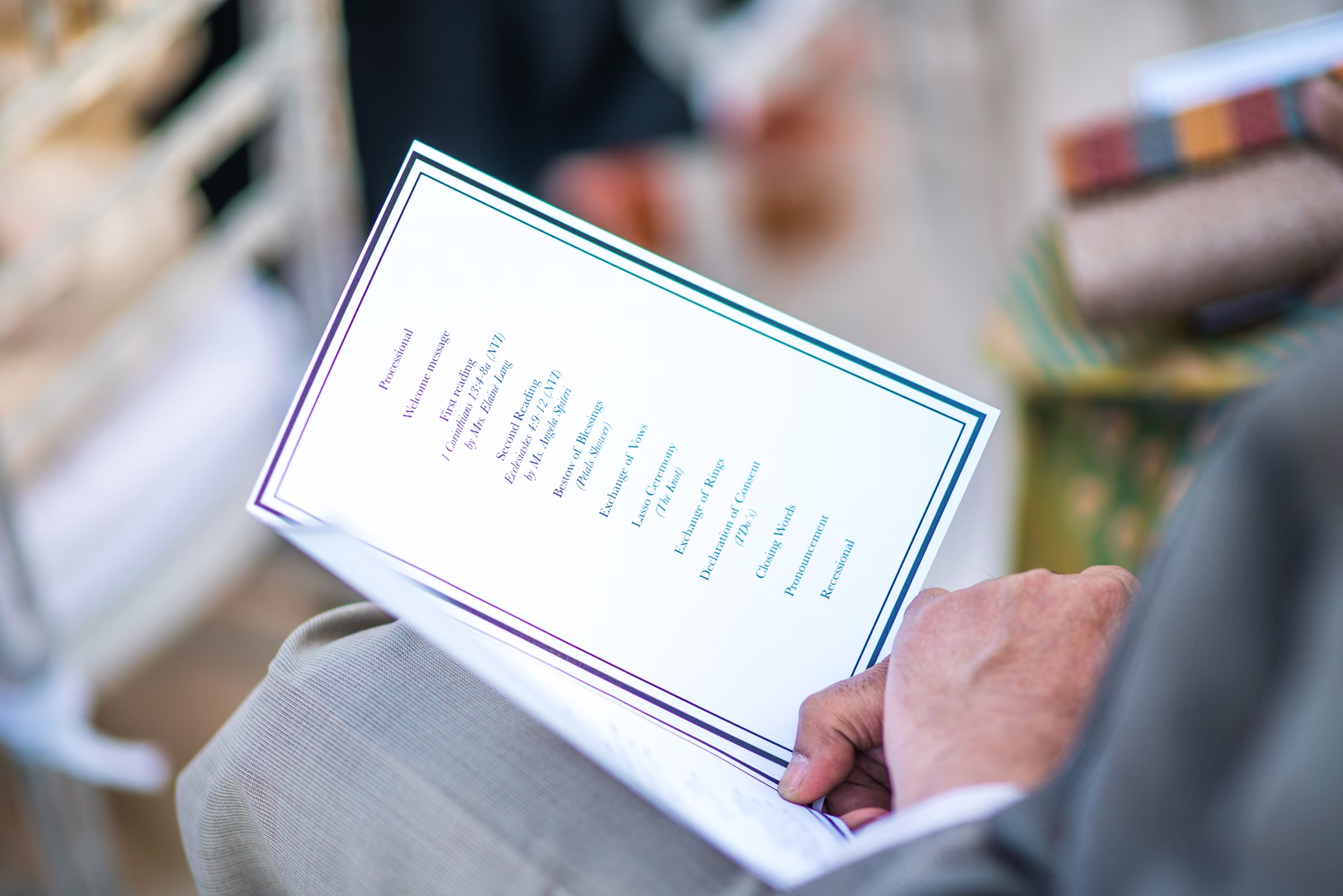 A wedding guest holds the printed ceremony program