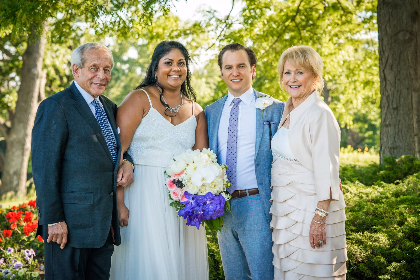 Avanti and Tony stand with the groom’s parents for an outdoor family portrait at Interlachen Country Club