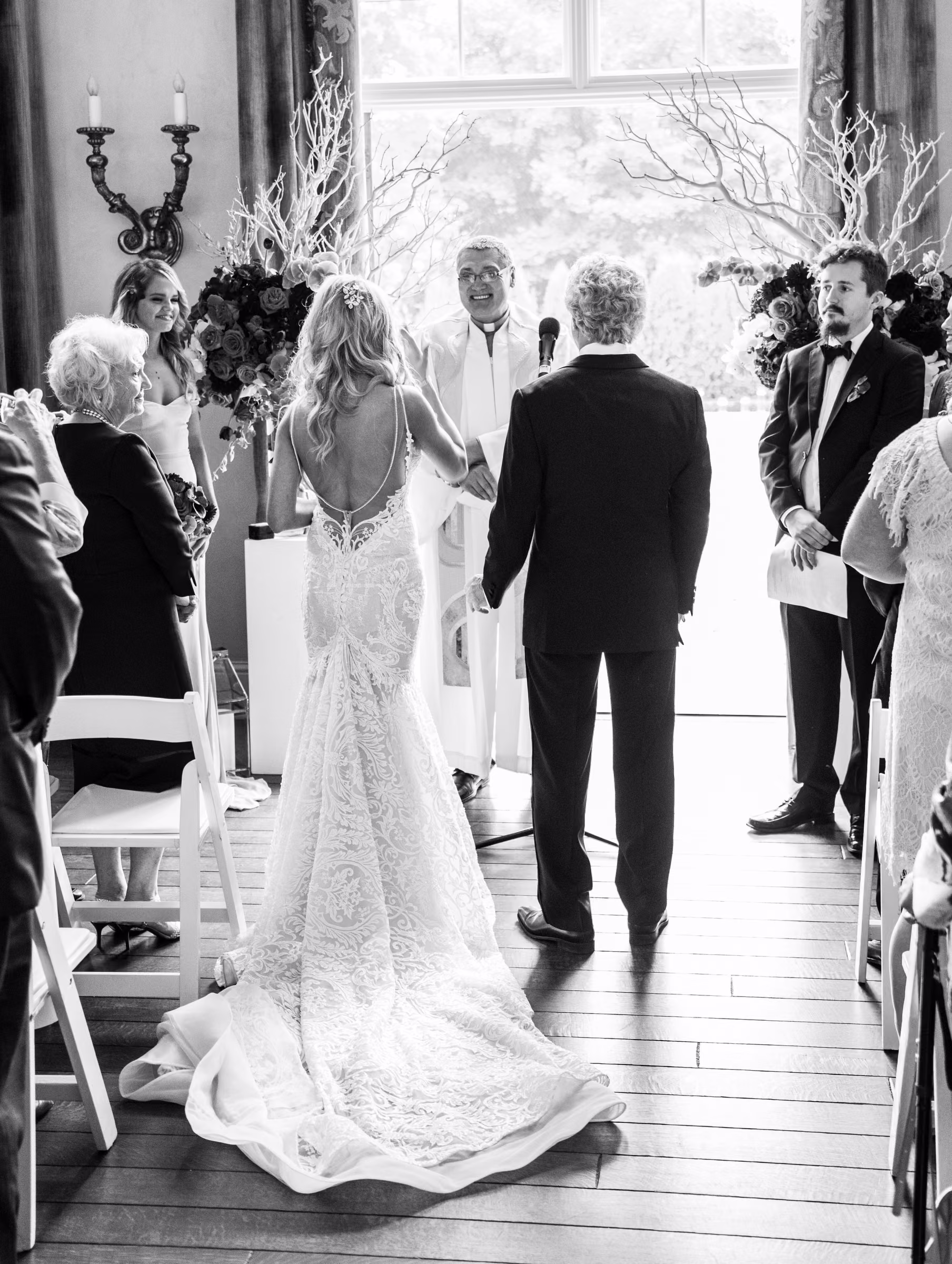Bill and Daiva walk together toward their family and friends inside the home