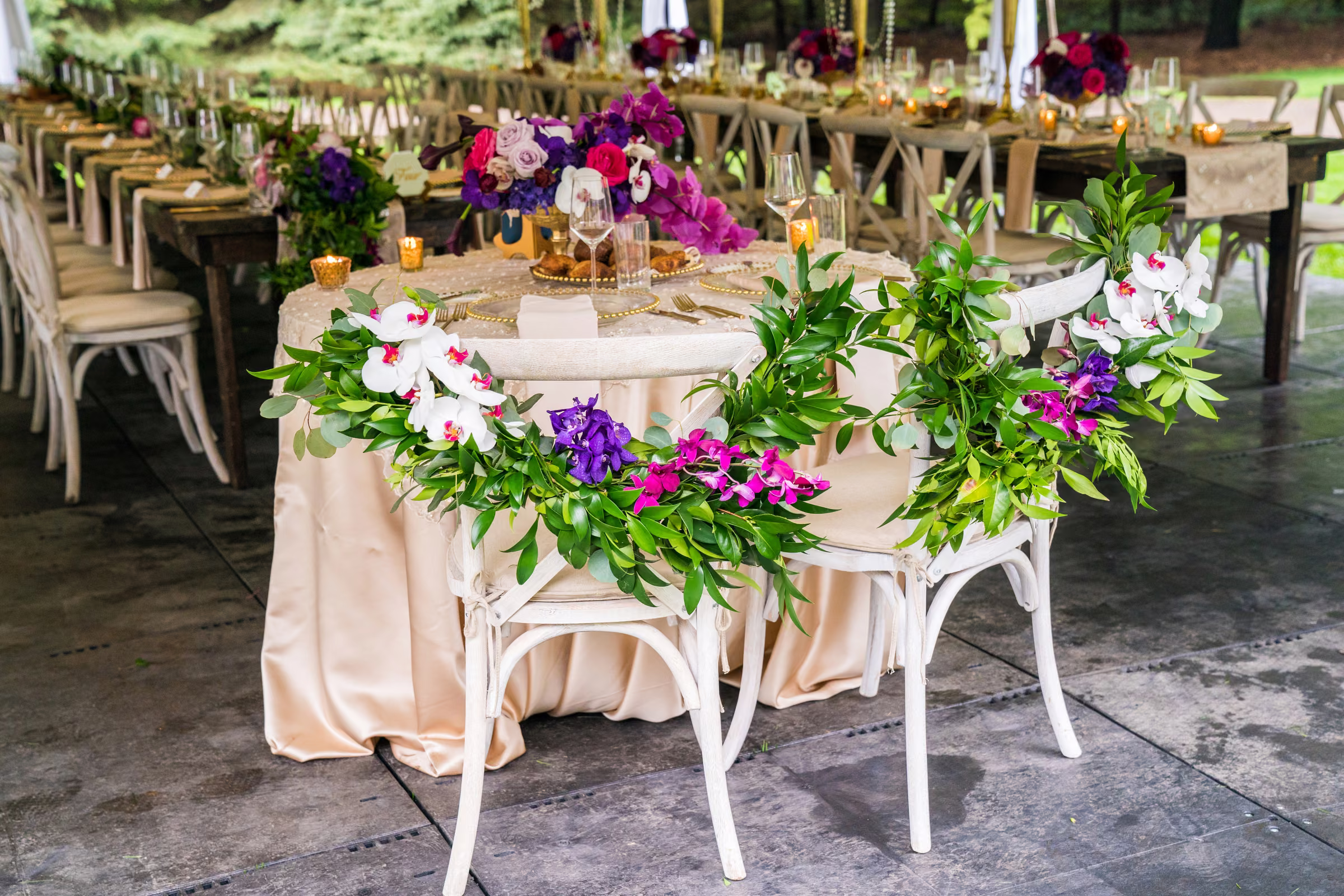 Floral garlands decorate the backs of Bill and Daiva’s reception chairs