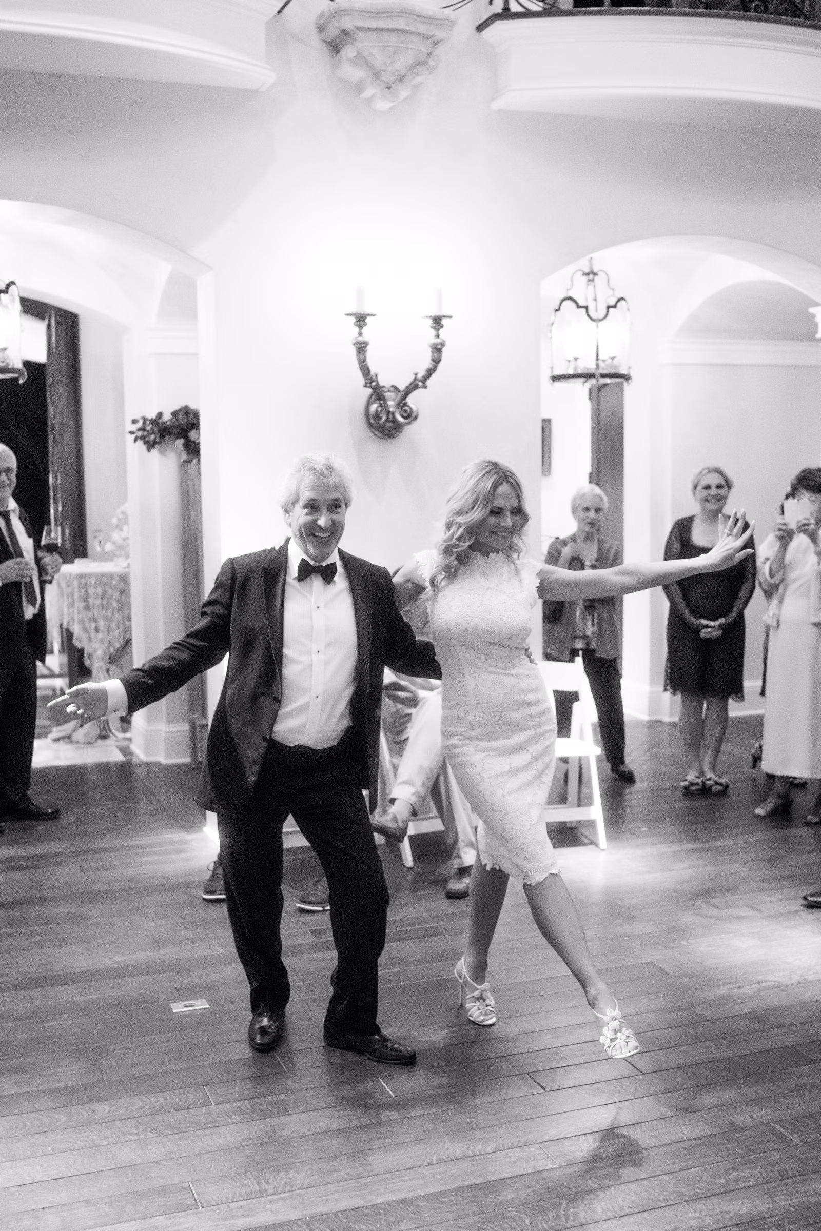 Bill and Daiva dance together as guests watch from the edge of the room