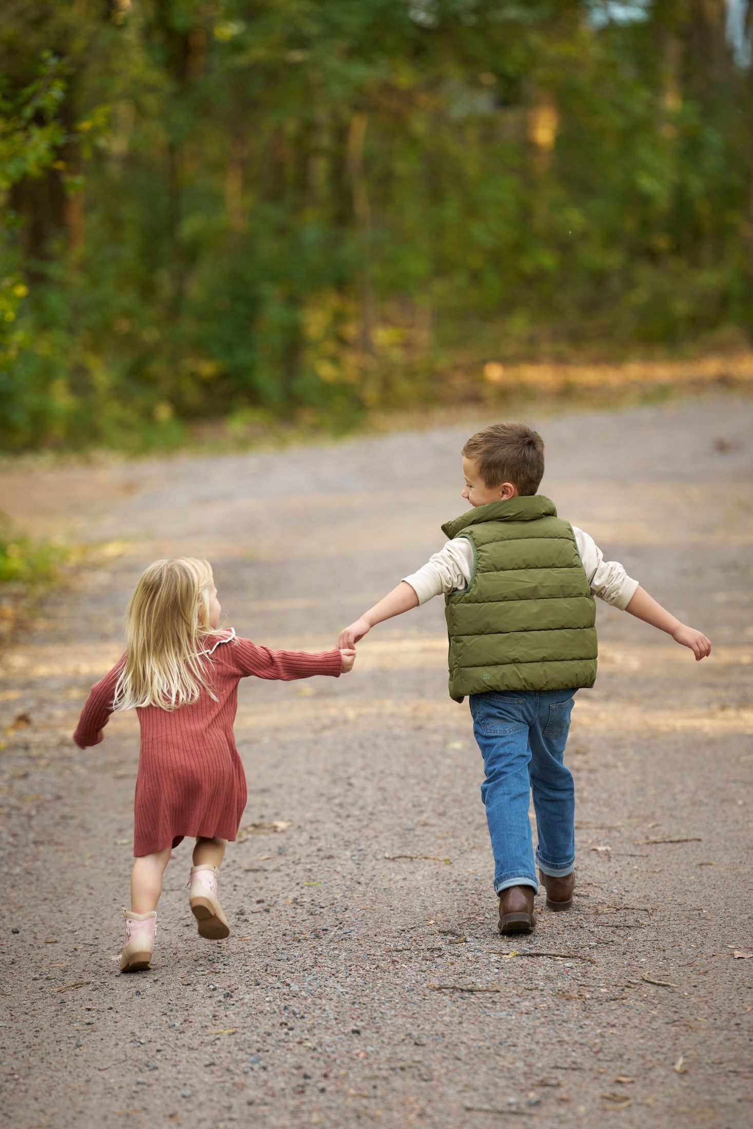 The Engle children walking hand in hand along their quiet lane in Orono, Minnesota