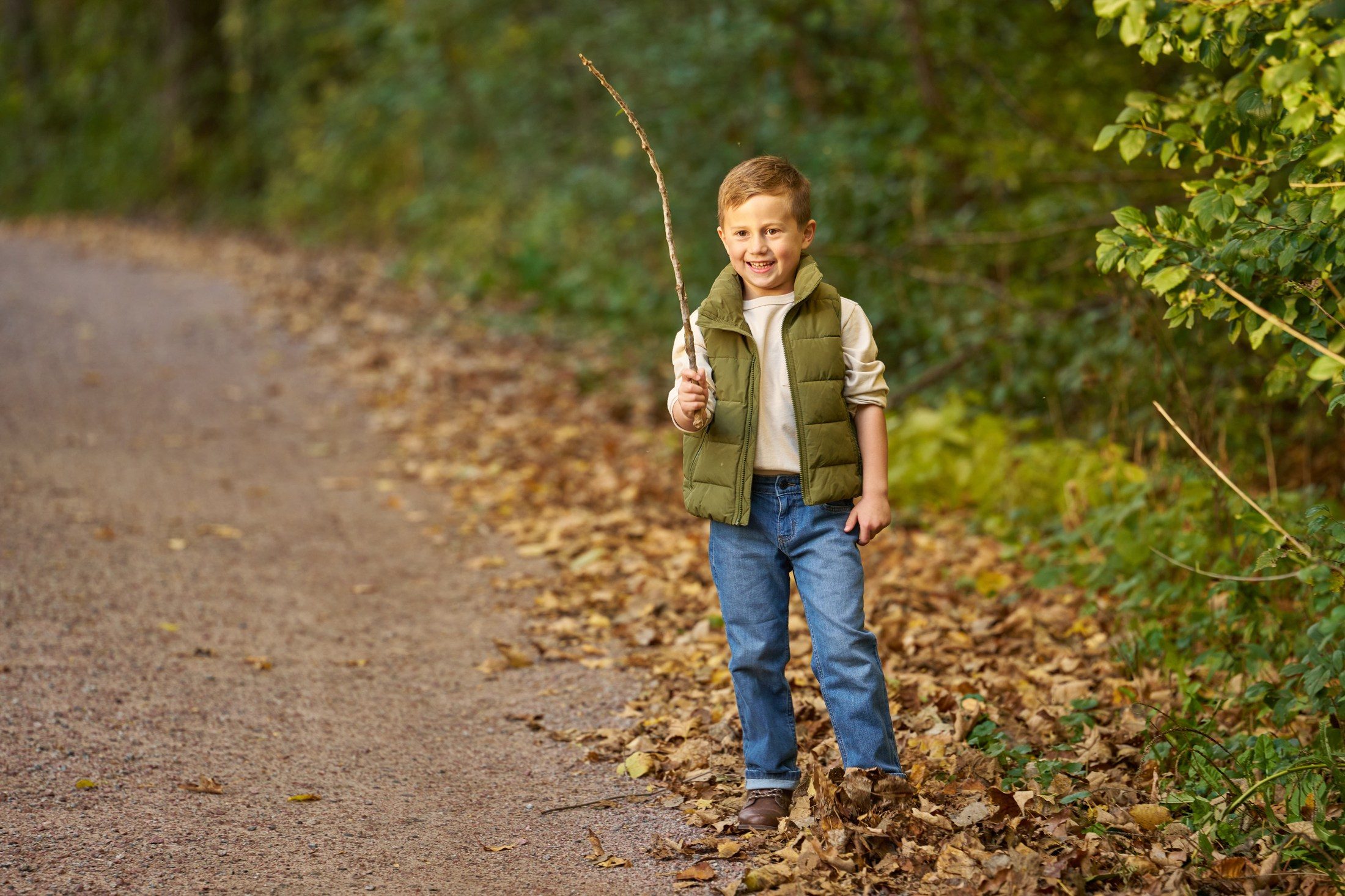 The Engles’ son holding a long stick beside the lane in Orono, Minnesota