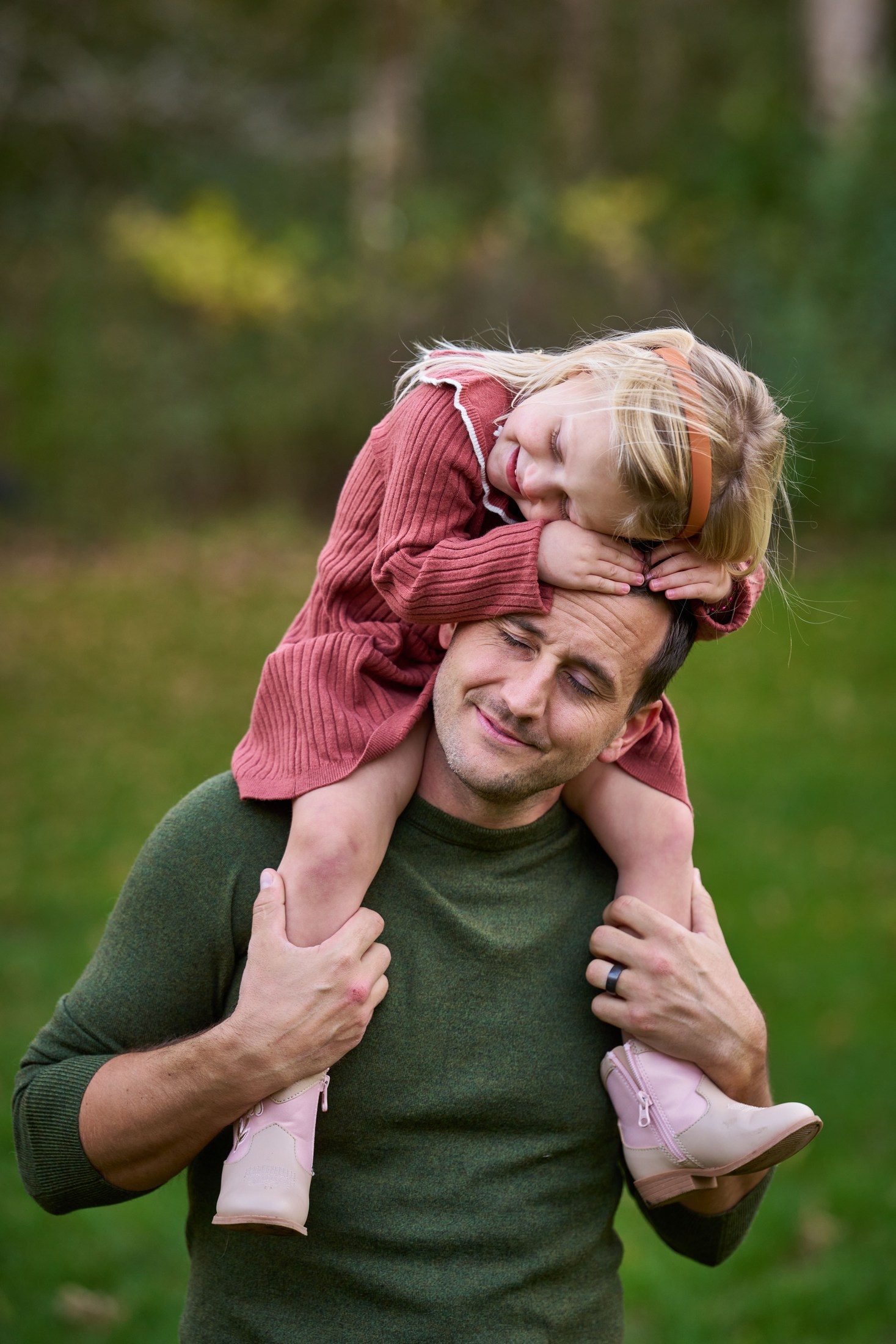 The Engles’ daughter resting her head on her hands while riding on her father’s shoulders in Orono, Minnesota