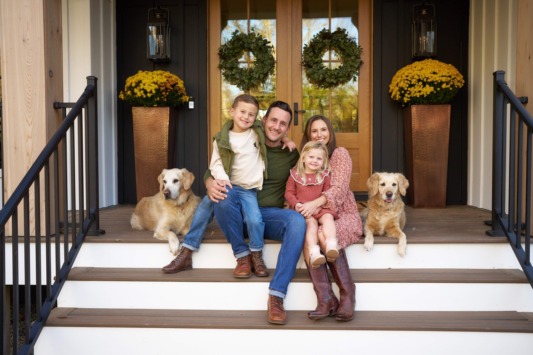 The Engle family and their two golden retrievers on their front porch in Orono, Minnesota