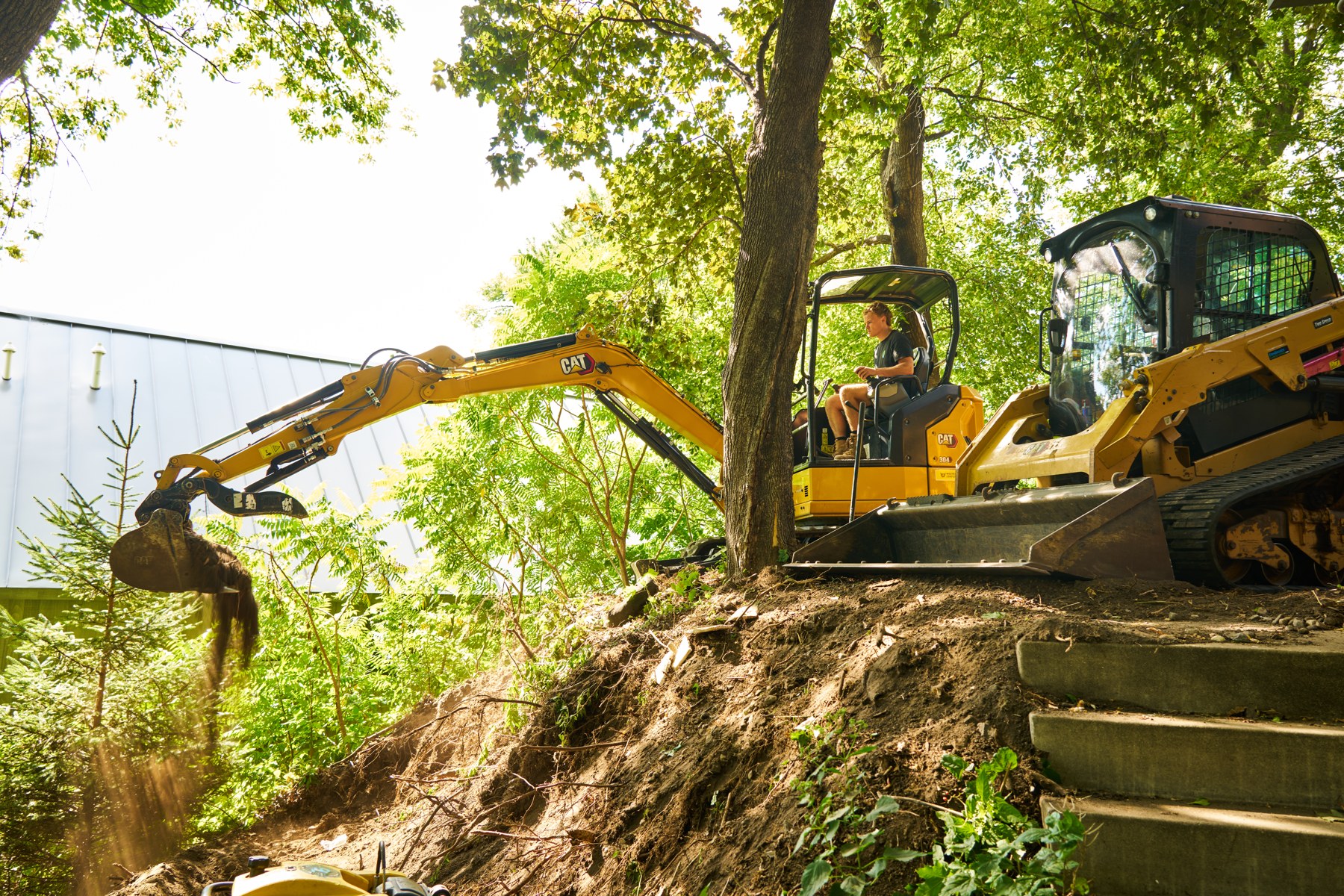 Charles operating an excavator on a hillside