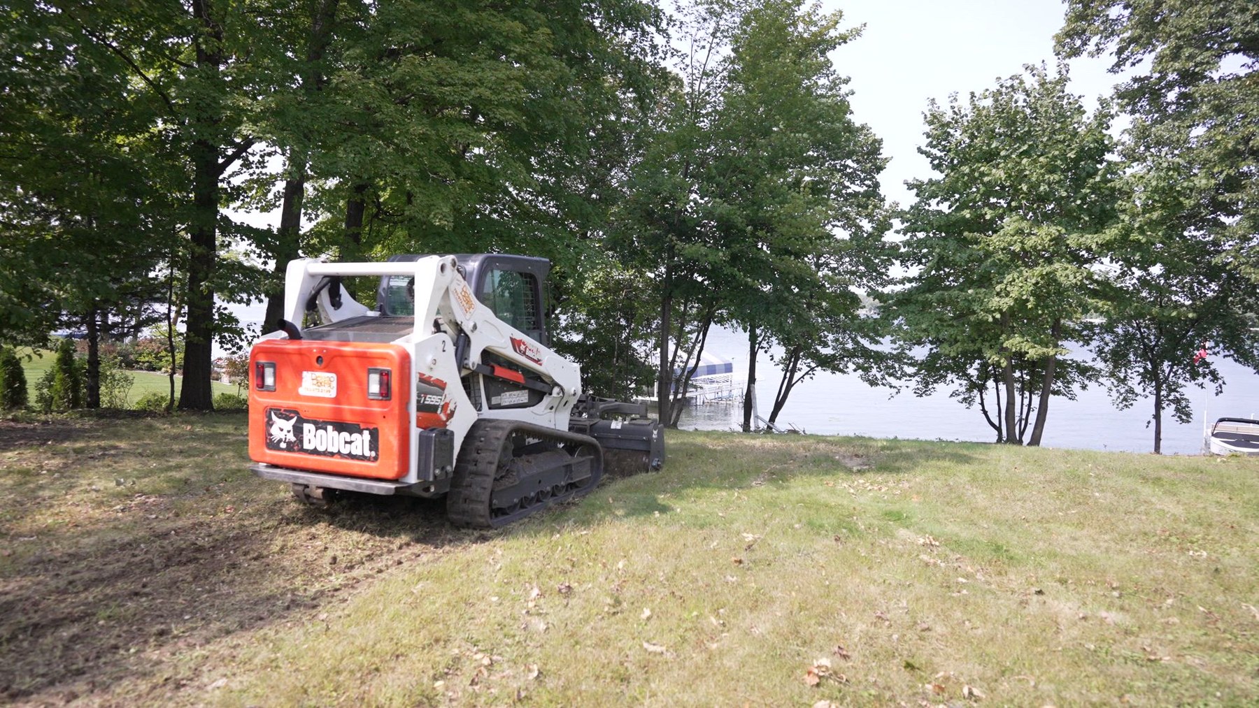 Freshwater grading a lot with Lake Minnetonka beyond the trees