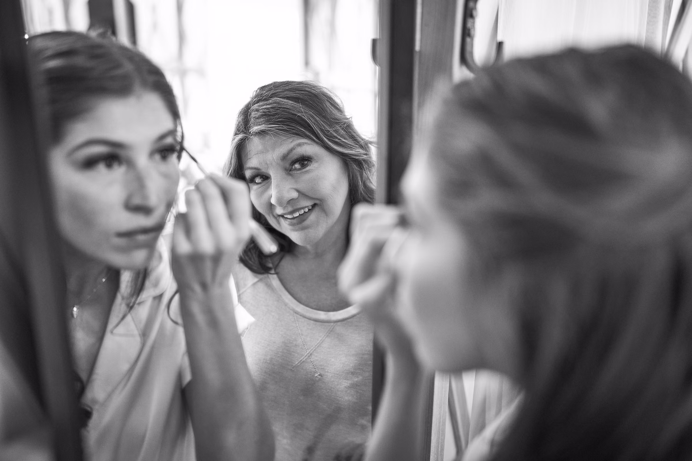 Gabby does her makeup while her mother’s smiling reflection appears in the mirror behind her, Hope Valley, California