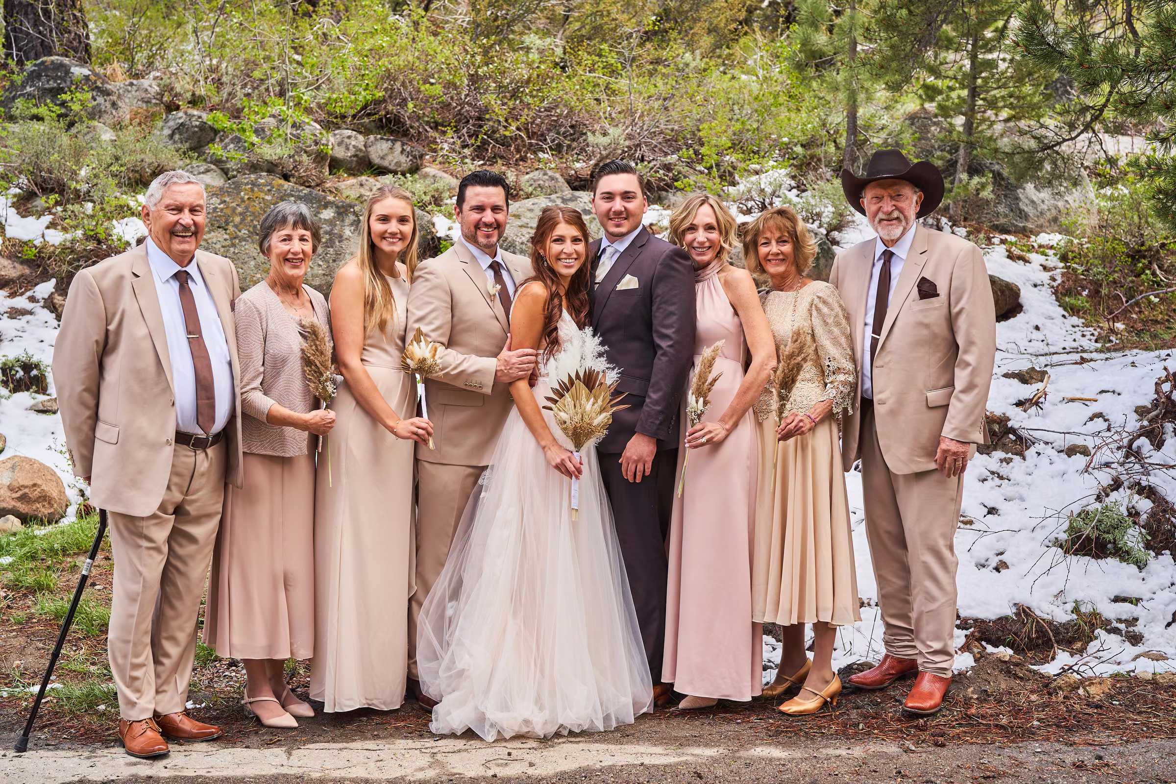 Joe and Gabby stand with the groom’s family among the trees and patches of snow, Hope Valley, California