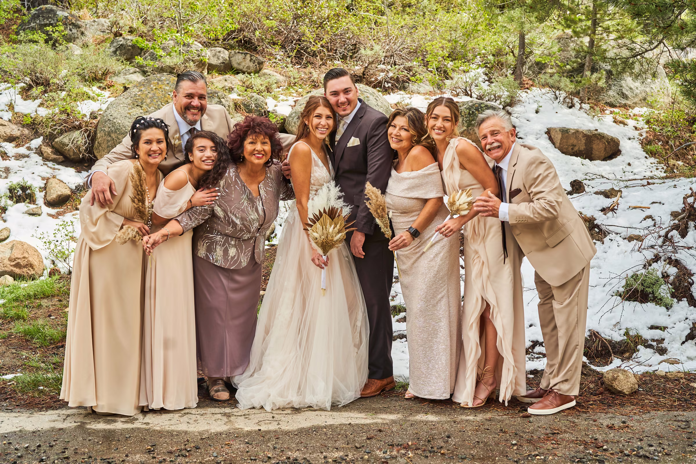 Joe and Gabby gather with the bride’s family for a lively group portrait in the snowy woods, Hope Valley, California