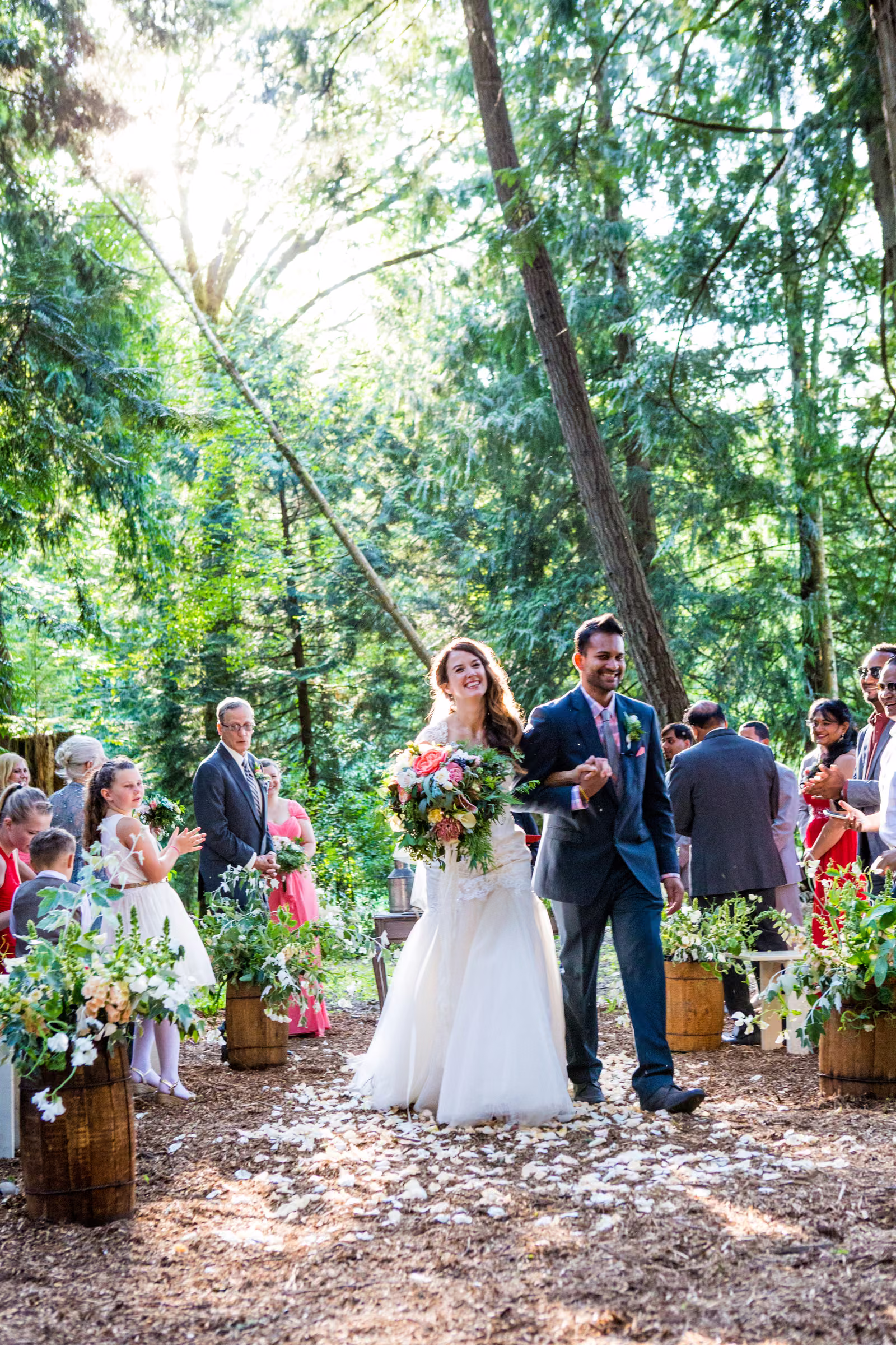 Kohleen and Kash walk hand in hand back through their guests after the ceremony