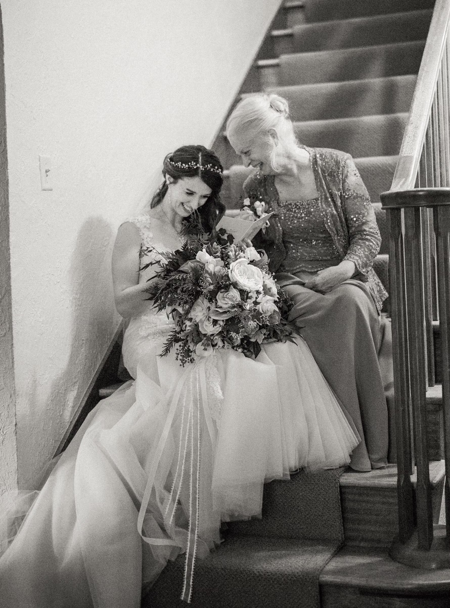 Kohleen leans against her mother on the staircase as they laugh and share an emotional moment