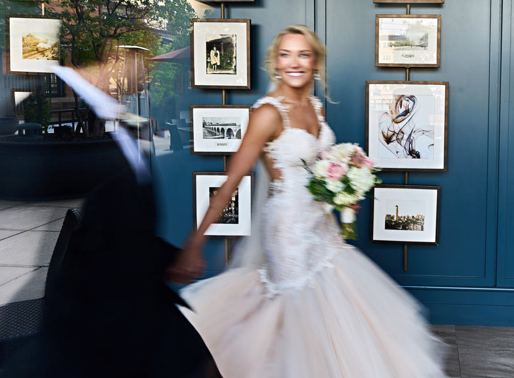 The wedding couple photographed through a window with a touch of motion blur