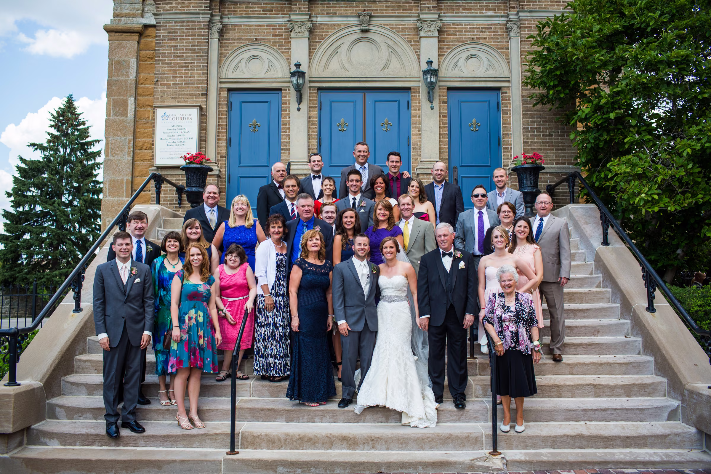 Matt and Annie gather with family for a group portrait on the church steps