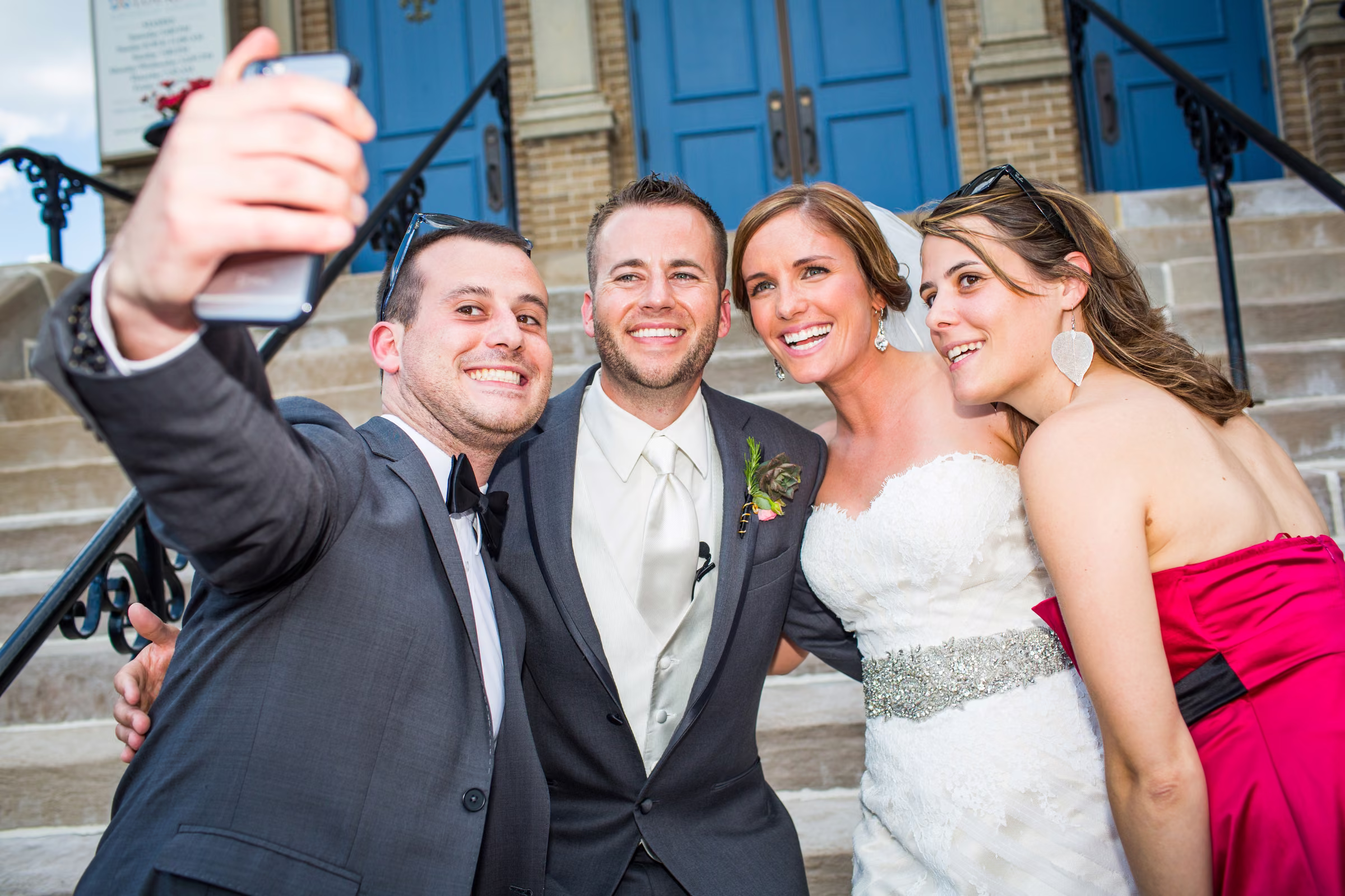 Matt, Annie, and friends lean together for a selfie outside the church