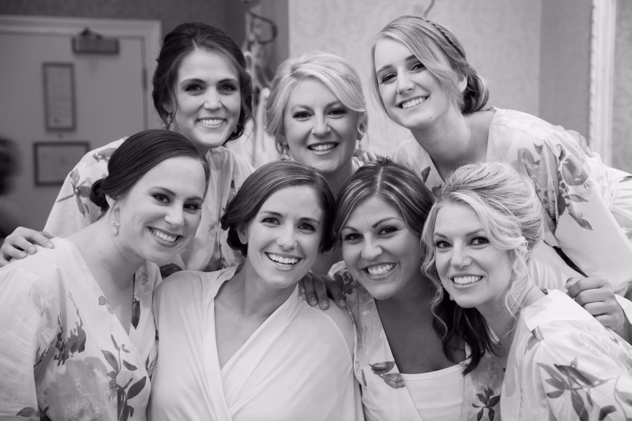 Annie and her friends gather in their robes for a black and white photograph in the bridal room
