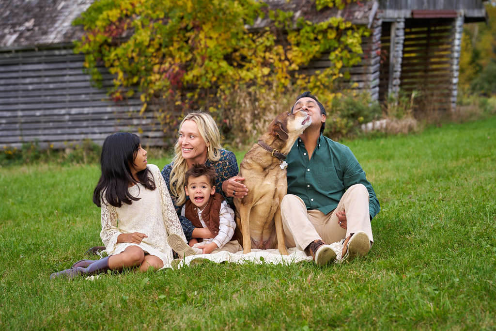 The Zaragoza family at the beginning of their pregnancy announcement, with their dog beside Alberto at Minnesota Landscape Arboretum, Chaska, Minnesota