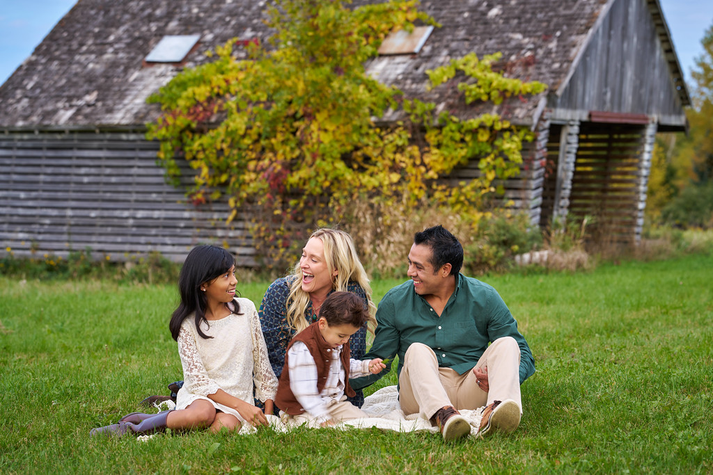 Vicky, Carrie, Alberto and their young boy sharing a moment after the pregnancy announcement at Minnesota Landscape Arboretum, Chaska, Minnesota