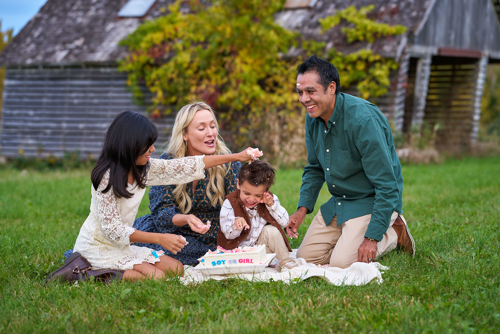 The Zaragoza family sharing cake and laughter after their gender reveal at Minnesota Landscape Arboretum, Chaska, Minnesota